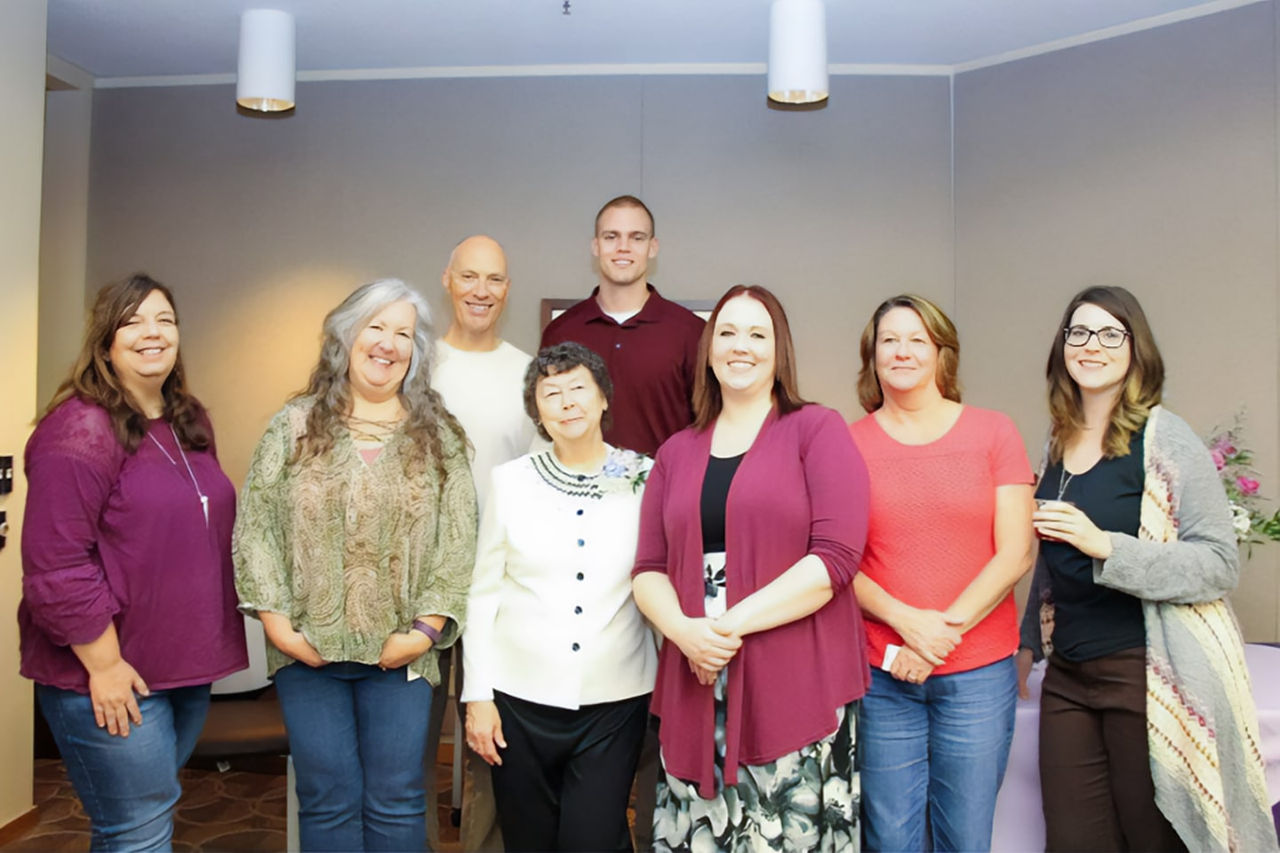Group of employees smiling and looking at the camera