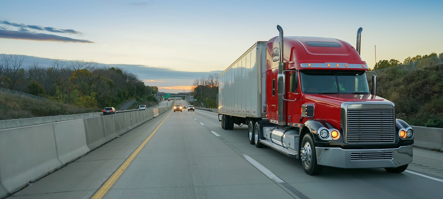 Red semi driving on the road
